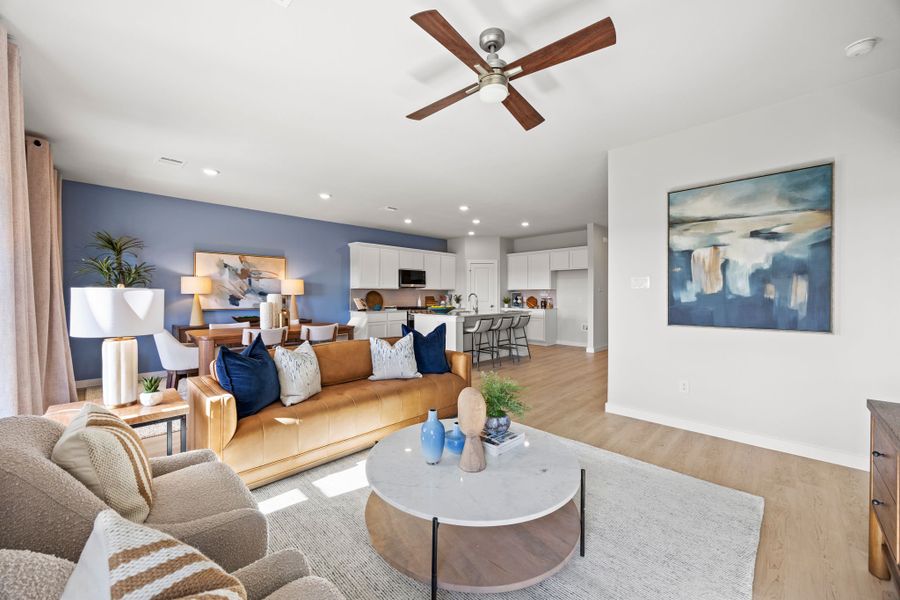 A living room with a couch and a table. A living room with a couch and a table.