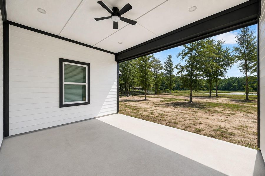 Spacious covered patio overlooking the expansive backyard.