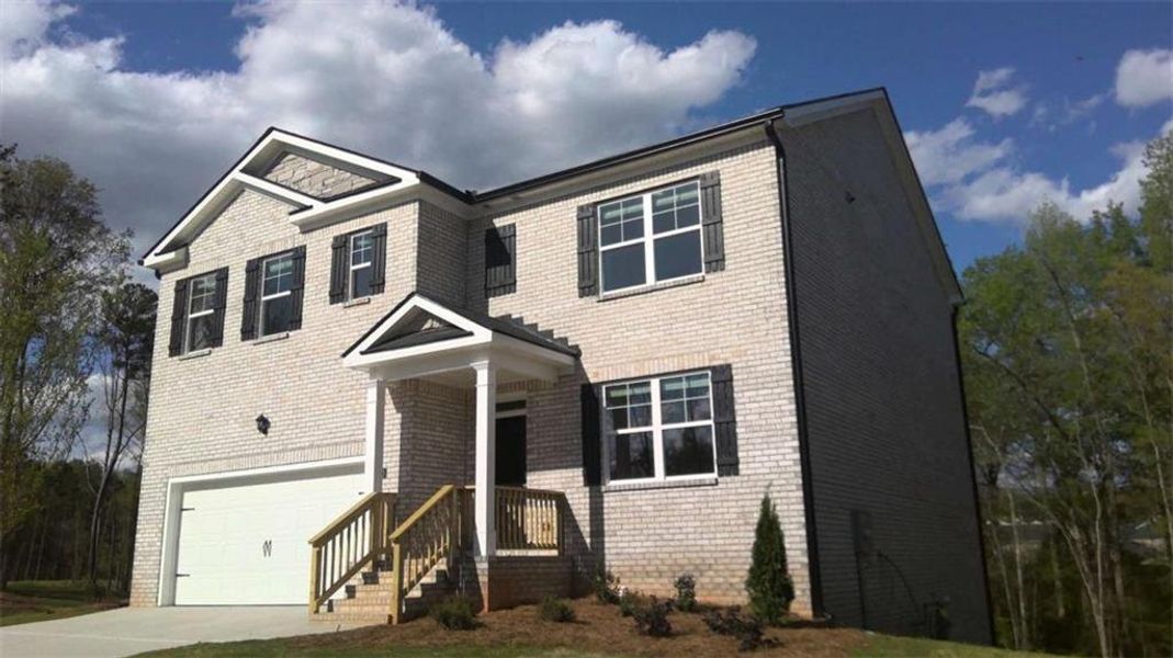 Front exterior of a new home in The Reserve at Calcutta, Stockbridge, GA, highlighting curb appeal (Image 29).