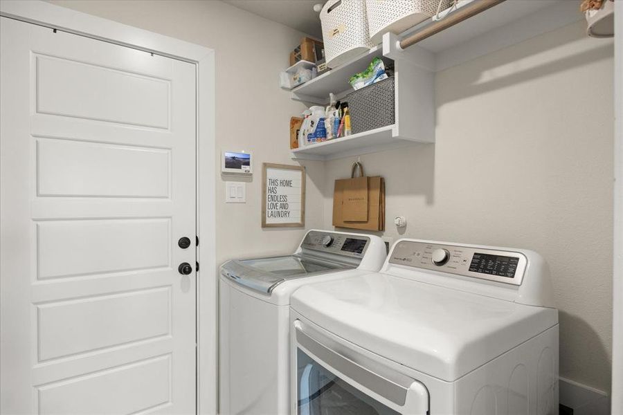 Washroom featuring washing machine and clothes dryer