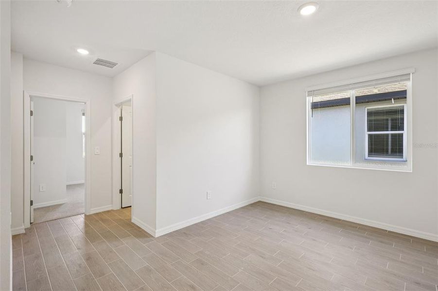 Spacious, unfurnished interior of a new home in The Grove at Stuart Crossing - Classic Series, Bartow (Image 25).