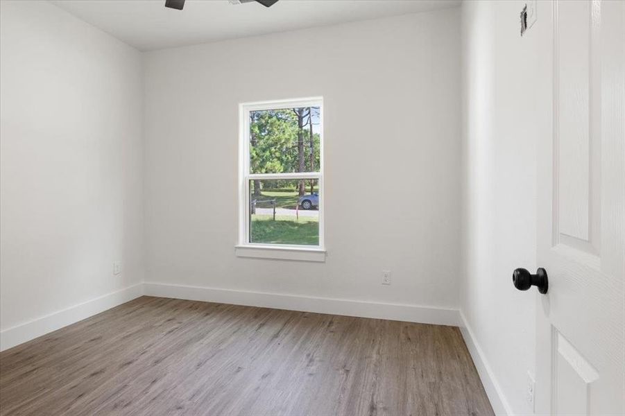 Spare room featuring ceiling fan and hardwood / wood-style floors