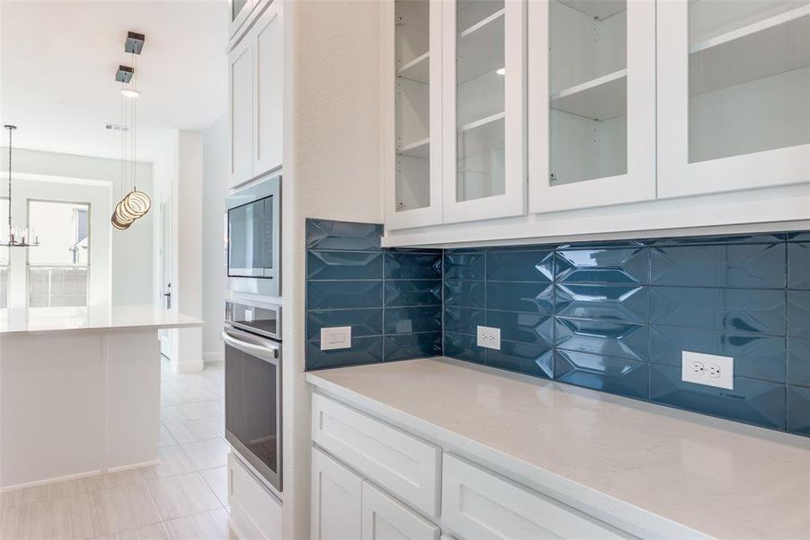 Butlers pantry with glass cabinets.