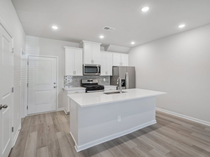 A sizeable kitchen island overlooks the sprawling great room.