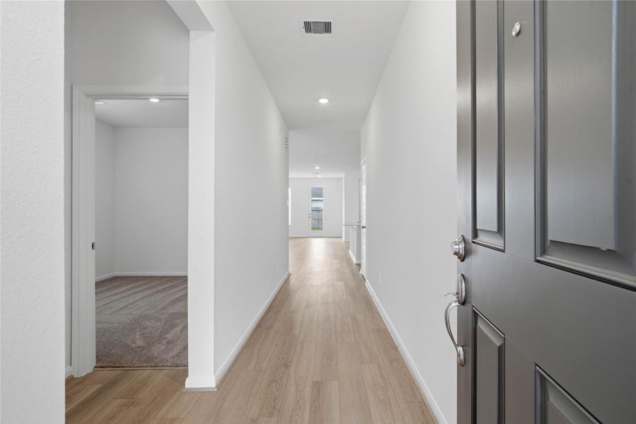 Welcome inside this lovely home of 3039 Cronus Way! This bright and welcoming entry features recessed lighting, bright neutral tone paint, and gorgeous Bandera vinyl plank flooring in French Oak.
