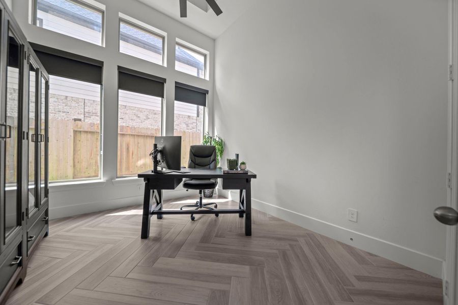Sunlit home office with tall windows and custom herringbone floors. A quiet space with plenty of natural light, ideal for working or studying. Sunlit home office with tall windows and custom herringbone floors. A quiet space with plenty of natural light, ideal for working or studying.
