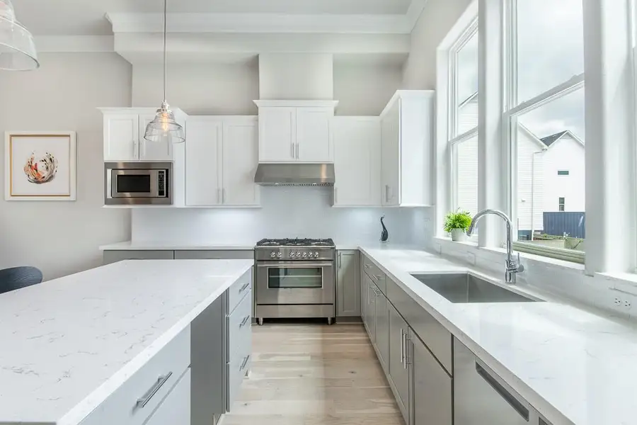 Fisher and Paykel upgraded appliances in this large kitchen and 3 windows.  Similar plan and finishes.