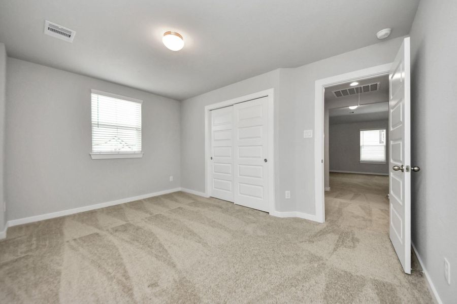 Generously sized secondary bedrooms featuring spacious closets, soft and inviting carpetingunderfoot, large windows allowing plenty of natural light, and the added touch of privacyblinds for your personal retreat.