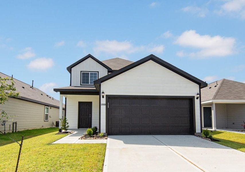 Front exterior of a new home in Townsend Reserve, Splendora, TX, highlighting curb appeal (Image 1). Front exterior of a new home in Townsend Reserve, Splendora, TX, highlighting curb appeal (Image 1).