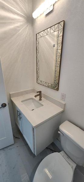 Bathroom featuring vanity and toilet