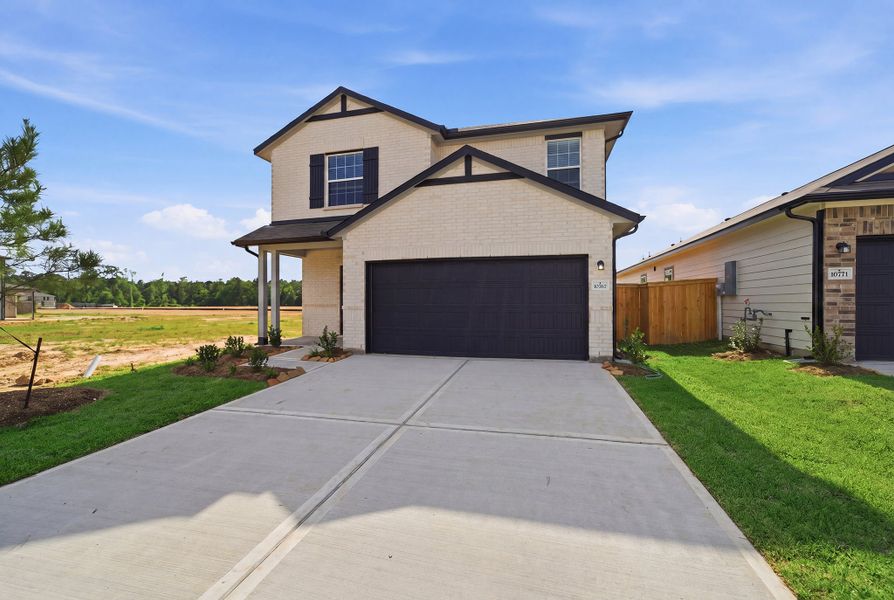 Front exterior of a new home in The Pines at Seven Coves, Willis, TX, highlighting curb appeal (Image 22).