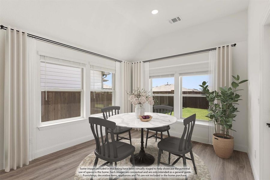 Bright breakfast nook with round marble table, four dark chairs, hardwood floors, and large windows with backyard view. Bright breakfast nook with round marble table, four dark chairs, hardwood floors, and large windows with backyard view.