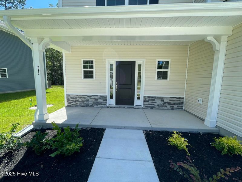 Front exterior of a new home in Mill Creek Cove, Bolivia, NC, highlighting curb appeal (Image 18).