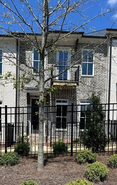 Exterior details and patio area of a home in Ward's Crossing Townhomes, Johns Creek (Image 3).