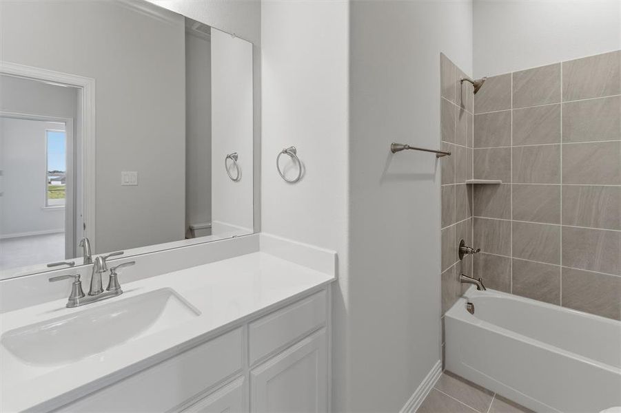 Bathroom featuring a vanity with a white countertop and an integrated sink, brushed nickel faucet, and a large wall-mounted mirror