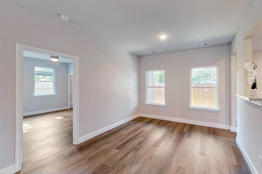 Unfurnished room with a wealth of natural light and hardwood / wood-style floors