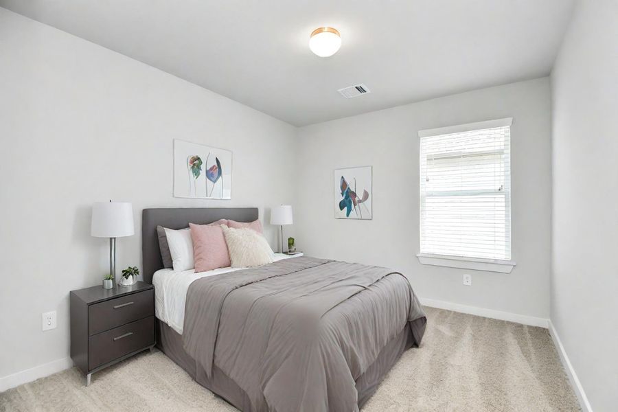 Generously sized secondary bedrooms, complete with spacious closets and soft, inviting carpeting. Sample photo of completed home with similar floor plan. Actual colors and selections may vary.