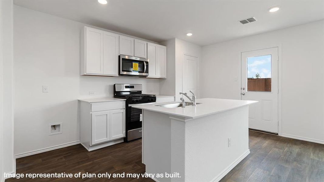 Kitchen with stainless steel appliances, white cabinets, dark wood-style floors, a kitchen island with sink, and recessed lighting