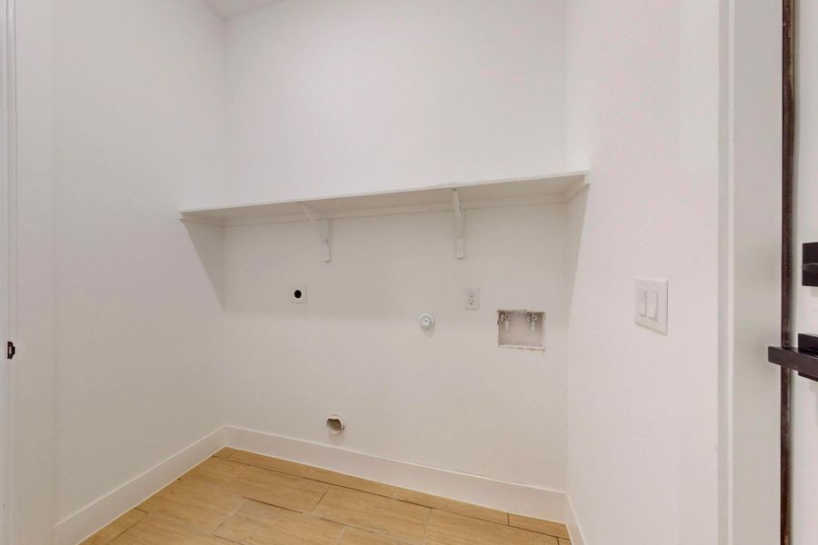 Laundry room featuring gas dryer hookup, wood tiled floors, washer hookup, and electric dryer hookup