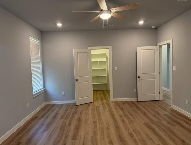 Beautiful primary bathroom with dual vanity, great natural light and gorgeous walk-in shower, with beautiful transom window.