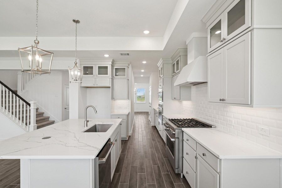 Stylish kitchen with stacked cabinets and quartz counters (*Photo not of actual home and used for illustration purposes only.) Stylish kitchen with stacked cabinets and quartz counters (*Photo not of actual home and used for illustration purposes only.)