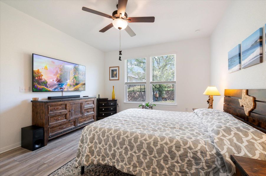 Bedroom with light wood-style floors and a ceiling fan Bedroom with light wood-style floors and a ceiling fan