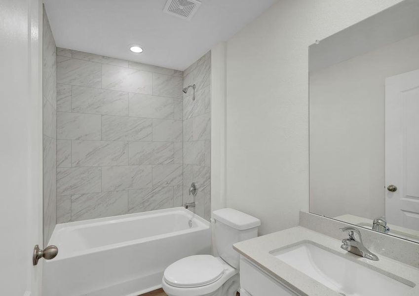 The secondary bathroom has a stunning vanity with a large soaker tub.