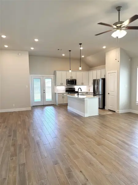 Open-concept living at its best with a spacious kitchen island & sink!