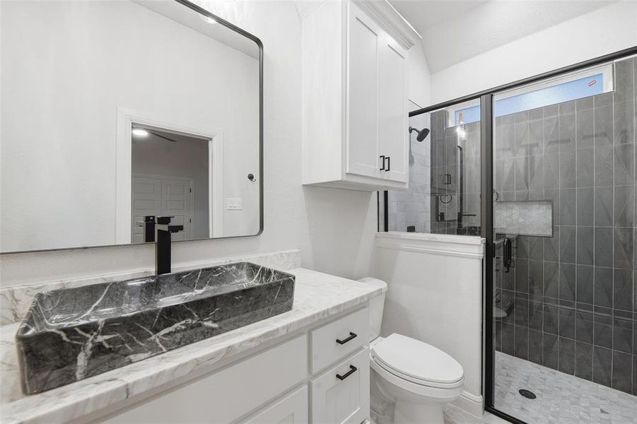 Full bath featuring vanity and a stall shower Full bath featuring vanity and a stall shower