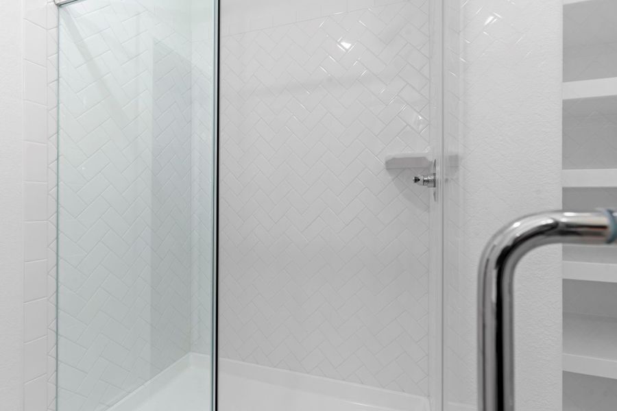 Enjoy a luxurious start to your day in this massive frameless glass shower, surrounded by elegant chic-style tile. Designed for comfort and style, it's paired with a tankless gas water heater for endless on-demand hot water. Enjoy a luxurious start to your day in this massive frameless glass shower, surrounded by elegant chic-style tile. Designed for comfort and style, it's paired with a tankless gas water heater for endless on-demand hot water.