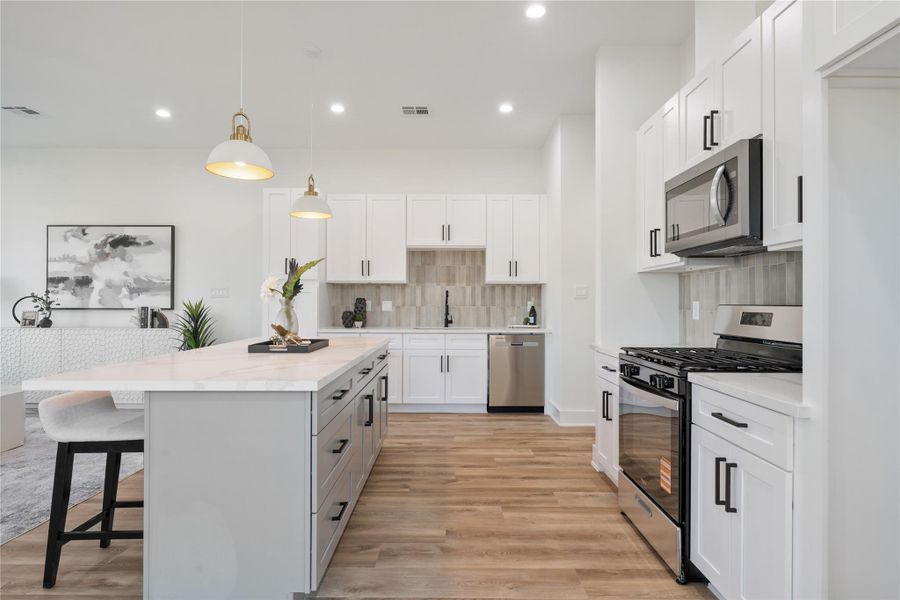 The kitchen offers tons of space, featuring abundant cabinetry that provides exceptional storage for all your essentials. Its functional layout keeps everything within reach while maintaining an open, airy feel. This combination of space and organization makes cooking and entertaining a breeze.