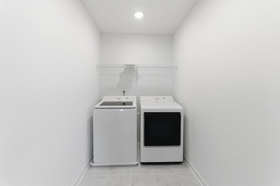 A white room with a white wall and a white stove.