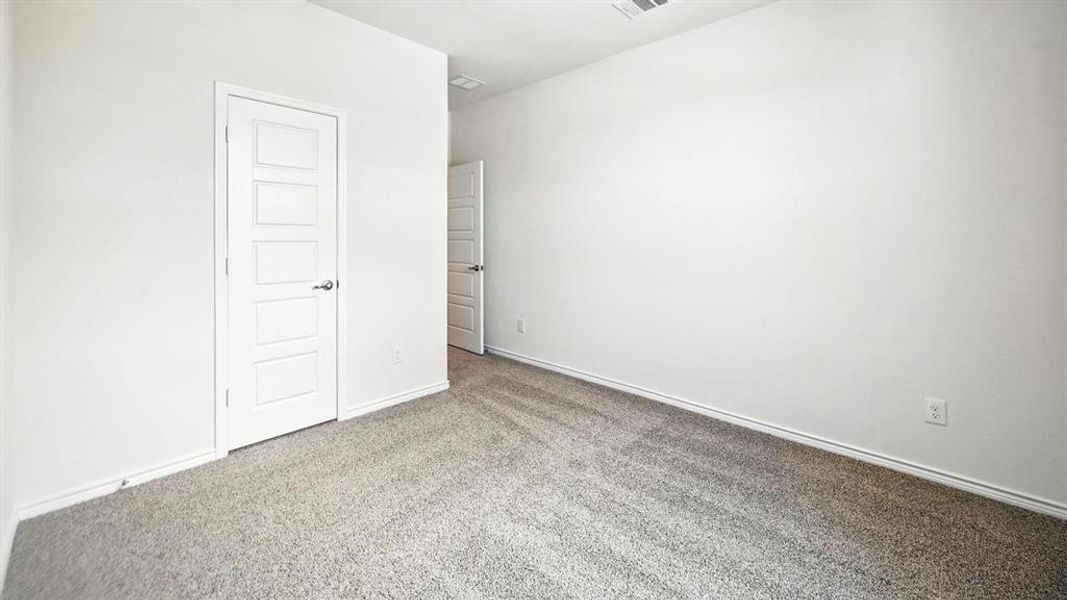Neutral tone-on-tone carpeting, crisp white walls, and contemporary five-panel interior doors