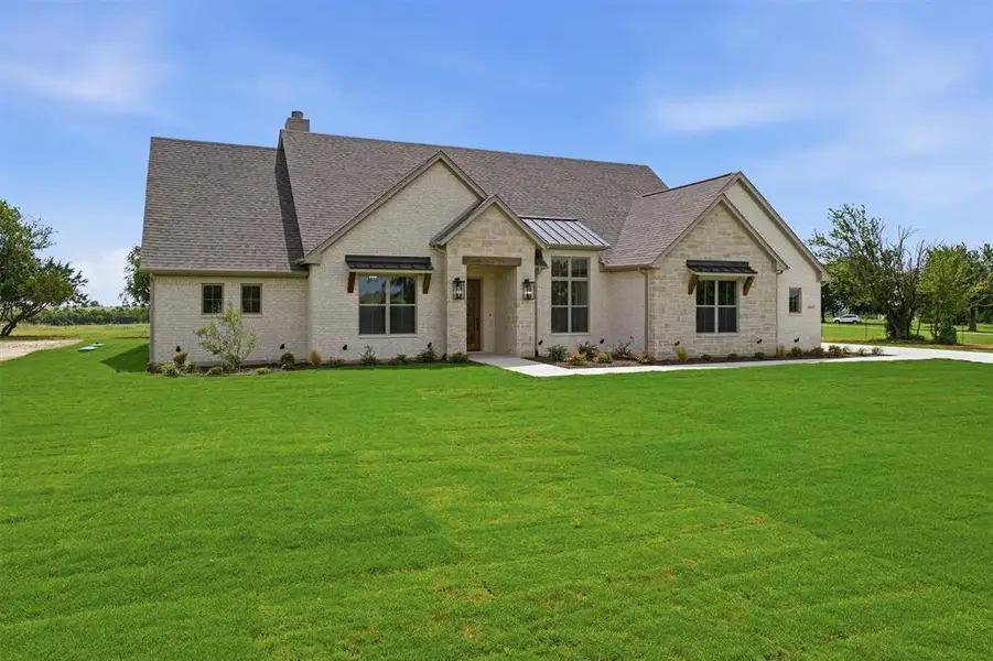 Front exterior of a new home in , Godley, TX, highlighting curb appeal (Image 2). Front exterior of a new home in , Godley, TX, highlighting curb appeal (Image 2).