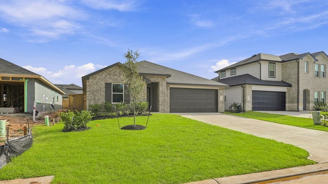 Front exterior of a new home in Mill Creek, Magnolia, TX, highlighting curb appeal (Image 21).