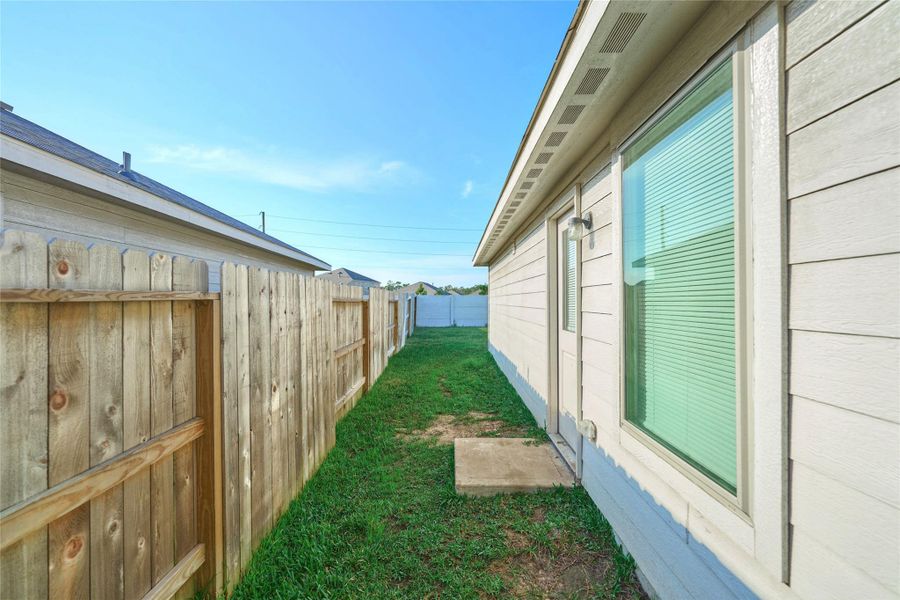 Exterior details and patio area of a home in Tavola: Cottage Collection, New Caney (Image 22).