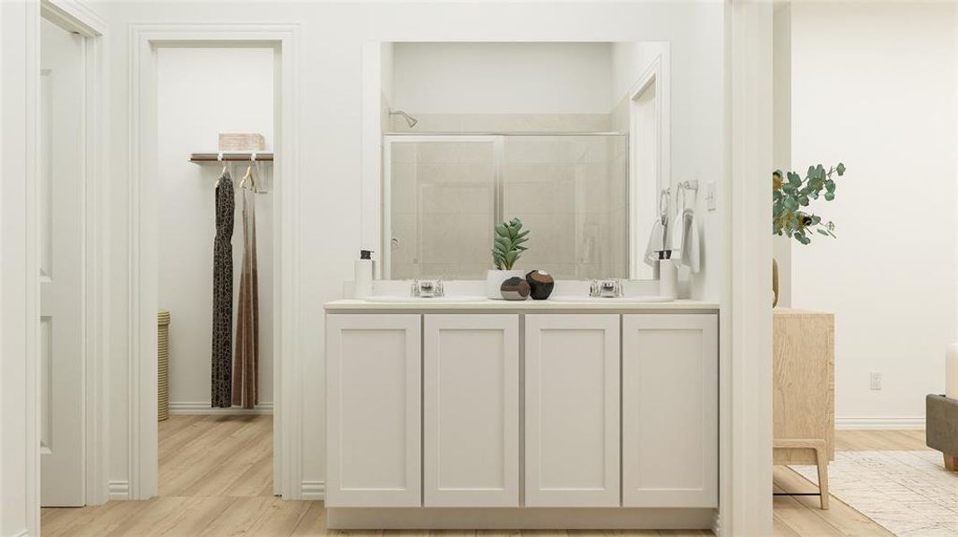 Bathroom with dual vanity and hardwood / wood-style flooring