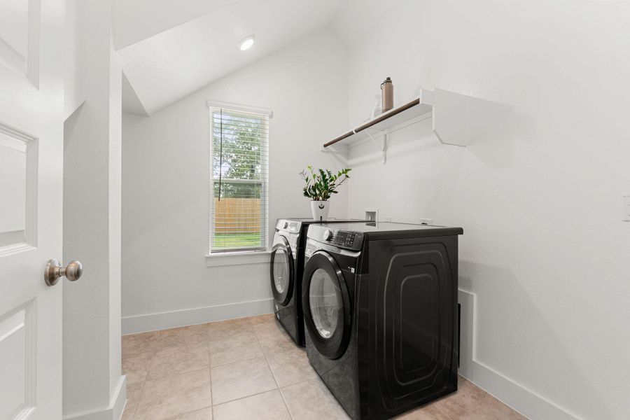 Laundry room with washer and clothes dryer, baseboards, and light tile patterned floors Laundry room with washer and clothes dryer, baseboards, and light tile patterned floors