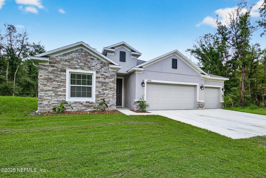 Front exterior of a new home in Flagler Estates, Hastings, FL, highlighting curb appeal (Image 23).