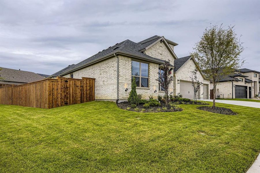 View of front of home with brick siding, concrete driveway, a garage, and a shingled roof View of front of home with brick siding, concrete driveway, a garage, and a shingled roof