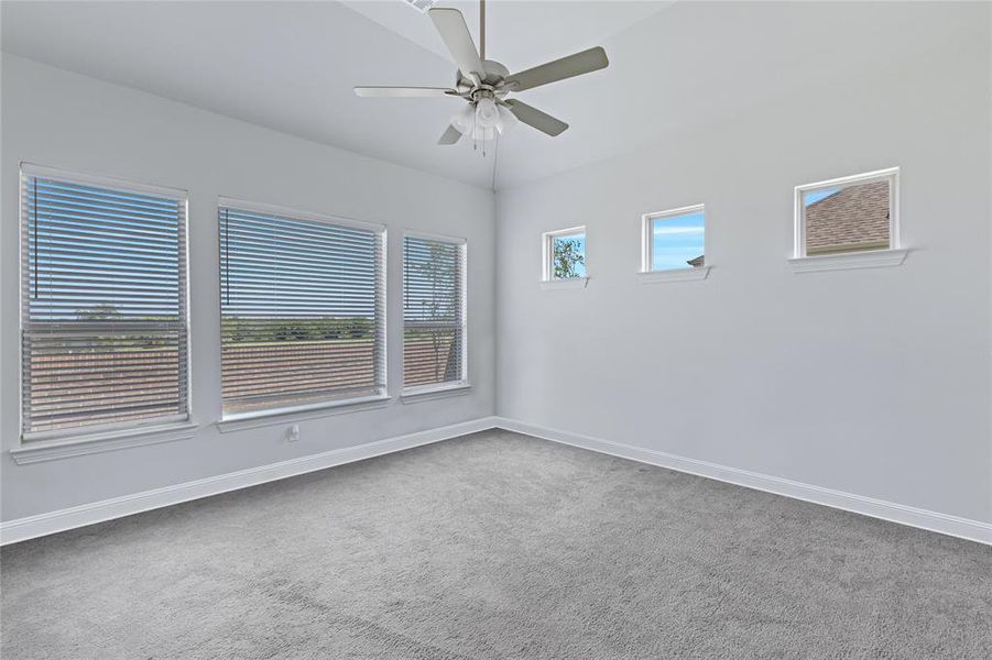 Unfurnished room with light carpet and a ceiling fan