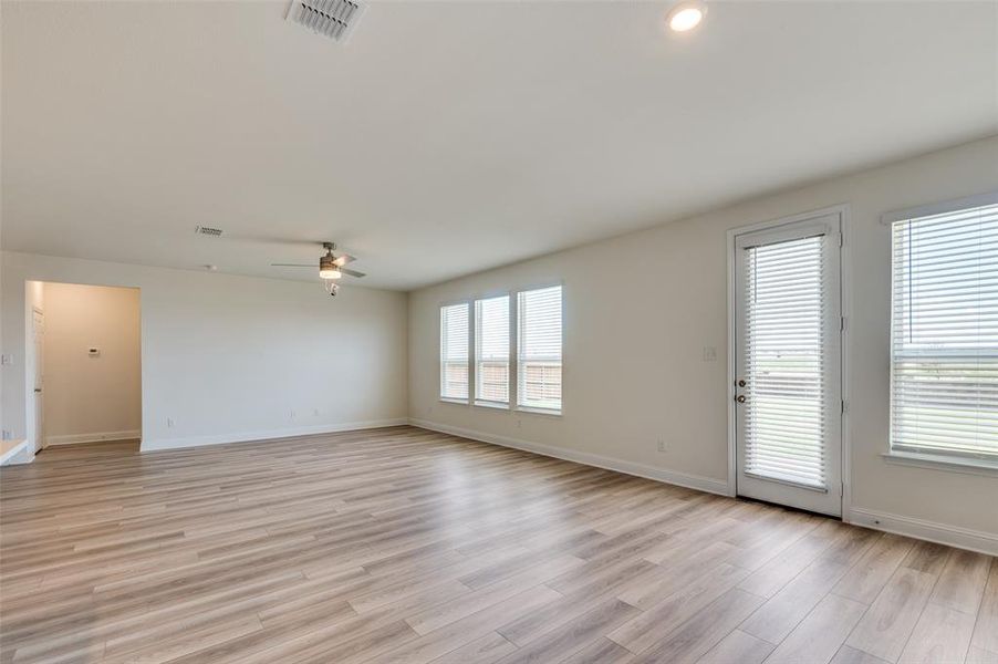 Empty room featuring a ceiling fan and light wood-style flooring