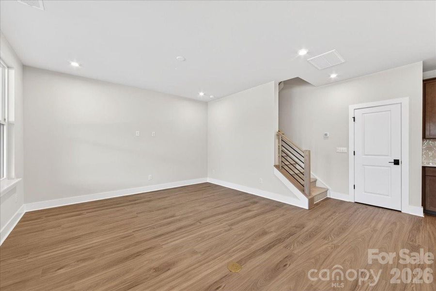Living room with open rails on the stairs
