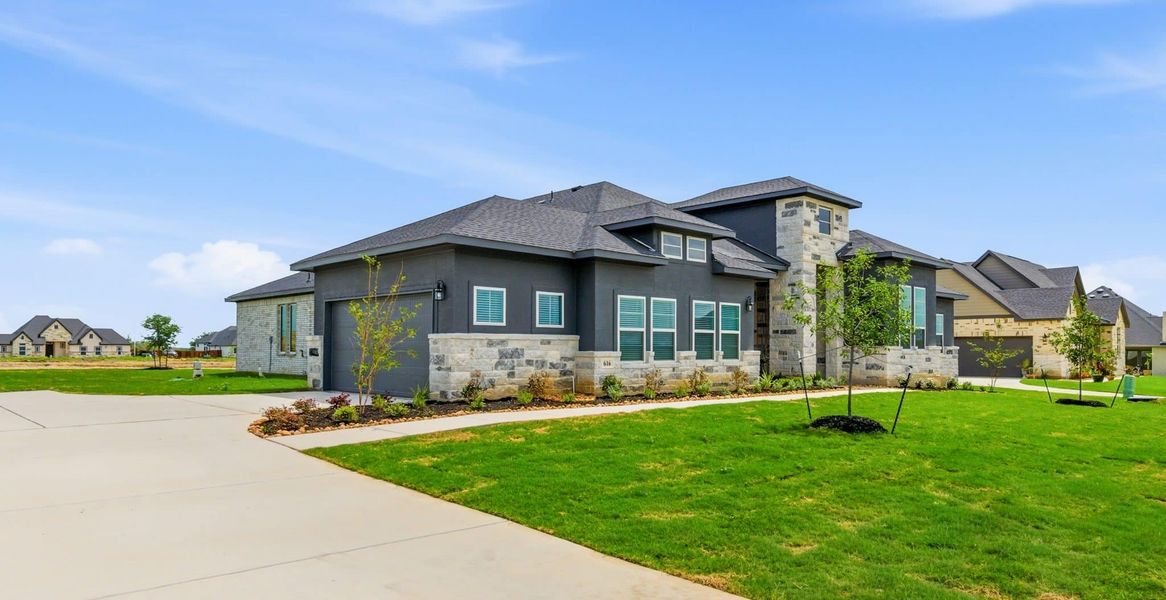 Front exterior of a new home in Sienna Lakes, San Antonio, TX, highlighting curb appeal (Image 28). Front exterior of a new home in Sienna Lakes, San Antonio, TX, highlighting curb appeal (Image 28).