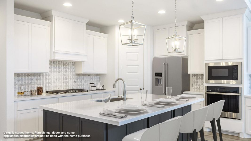 Kitchen featuring appliances with stainless steel finishes, a sink, recessed lighting, white cabinets, and light countertops Kitchen featuring appliances with stainless steel finishes, a sink, recessed lighting, white cabinets, and light countertops
