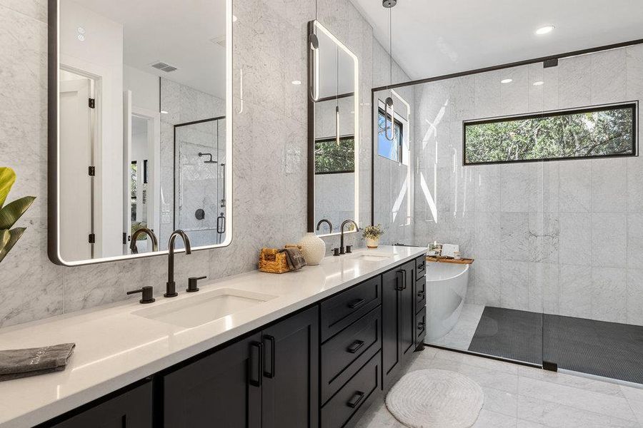 Enjoy your own private deluxe luxury ensuite bathroom with a custom dual vanity, premium countertops, and designer lighted mirrors.