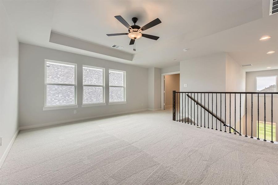 Unfurnished room with carpet, a tray ceiling, a ceiling fan, baseboards, and recessed lighting