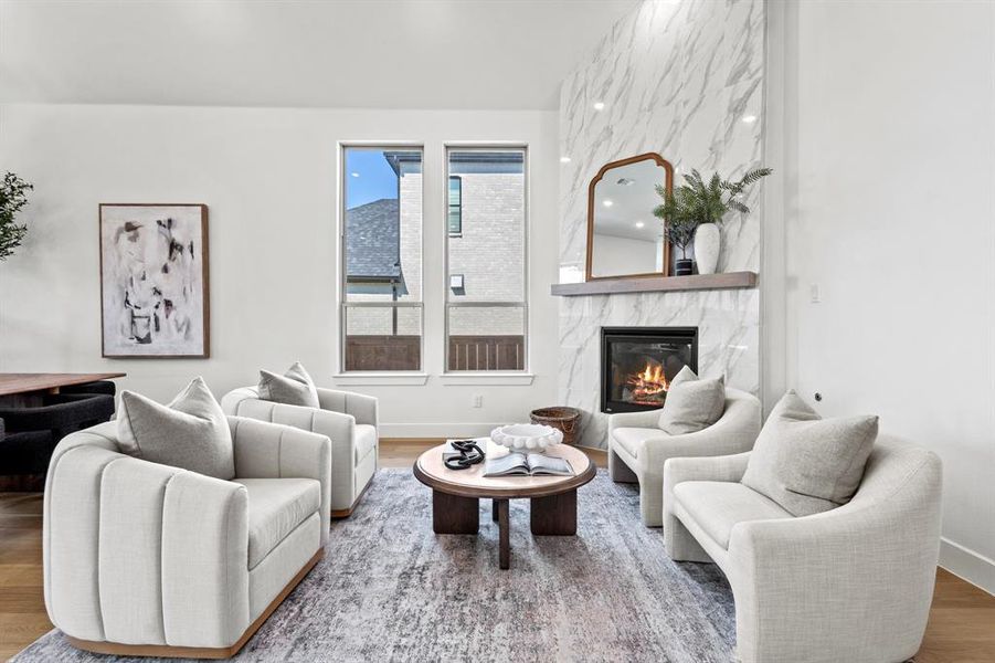 Living area with a fireplace and wood finished floors