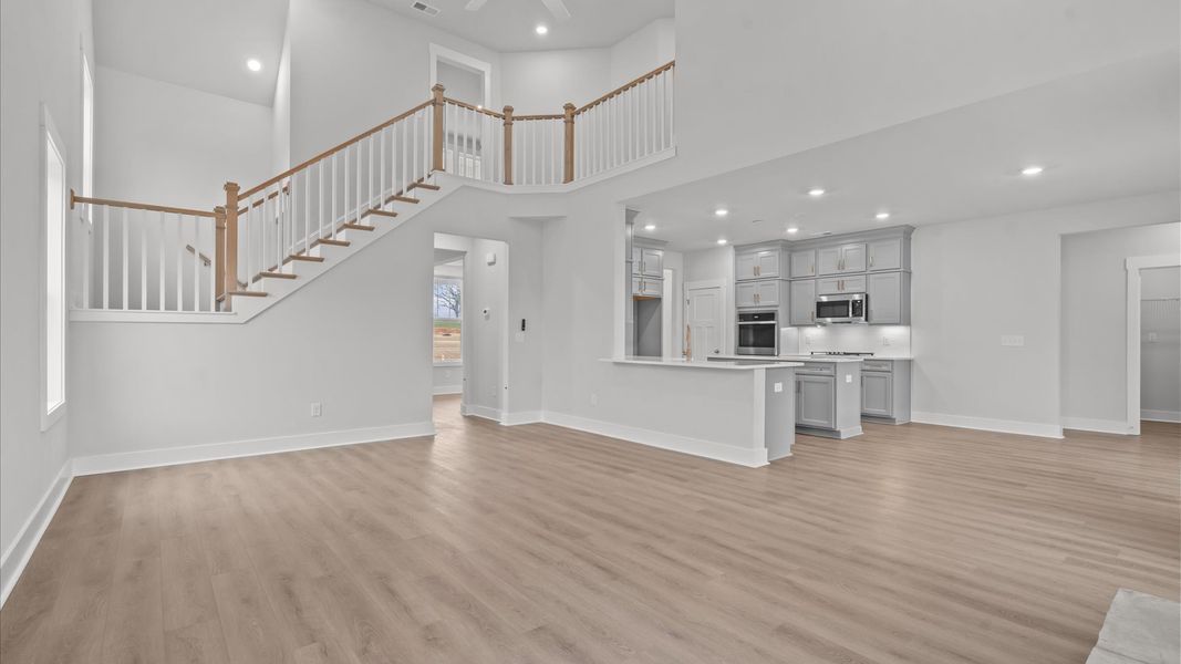Eye-catching two-story family room with elegant trim, oversized windows, and elevated design