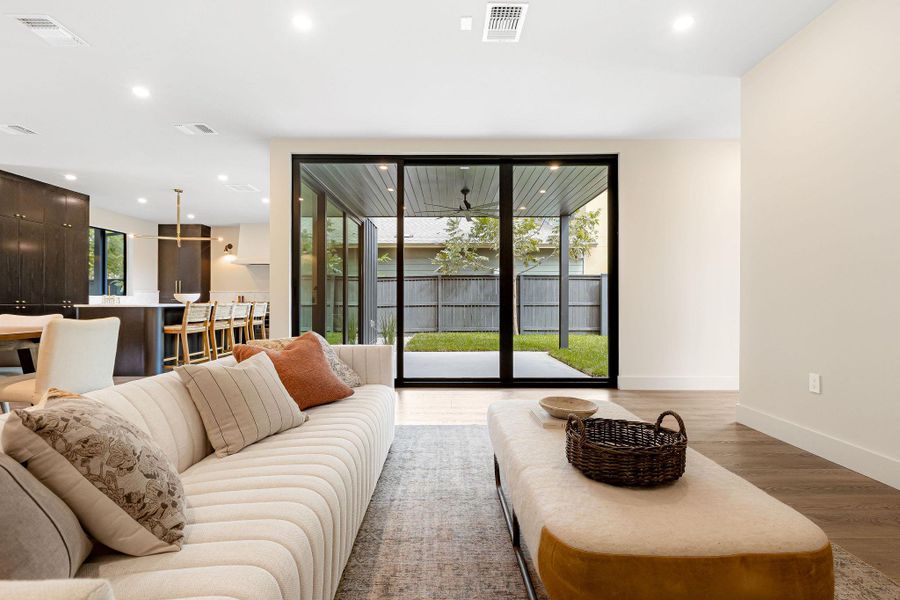 Living area with wood finished floors and recessed lighting